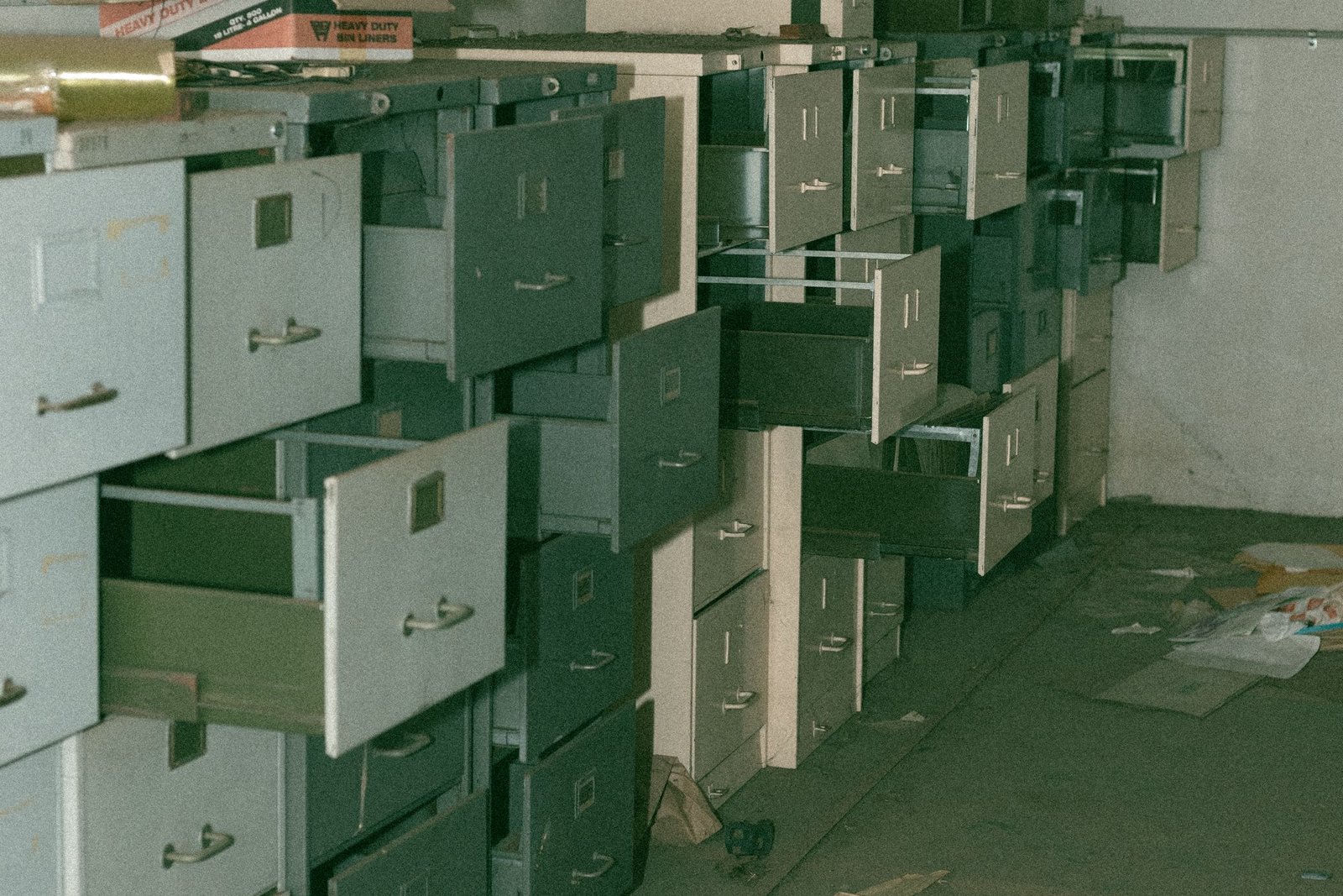 Rows of old filing cabinets with drawers left open